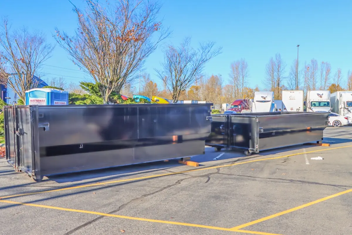 Professional dumpster rental service with roll-off container on residential driveway in Conneaut